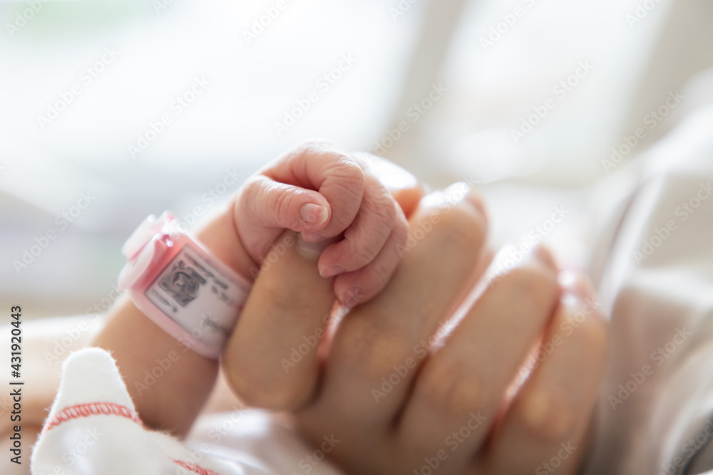 Holding a hand of a new born baby